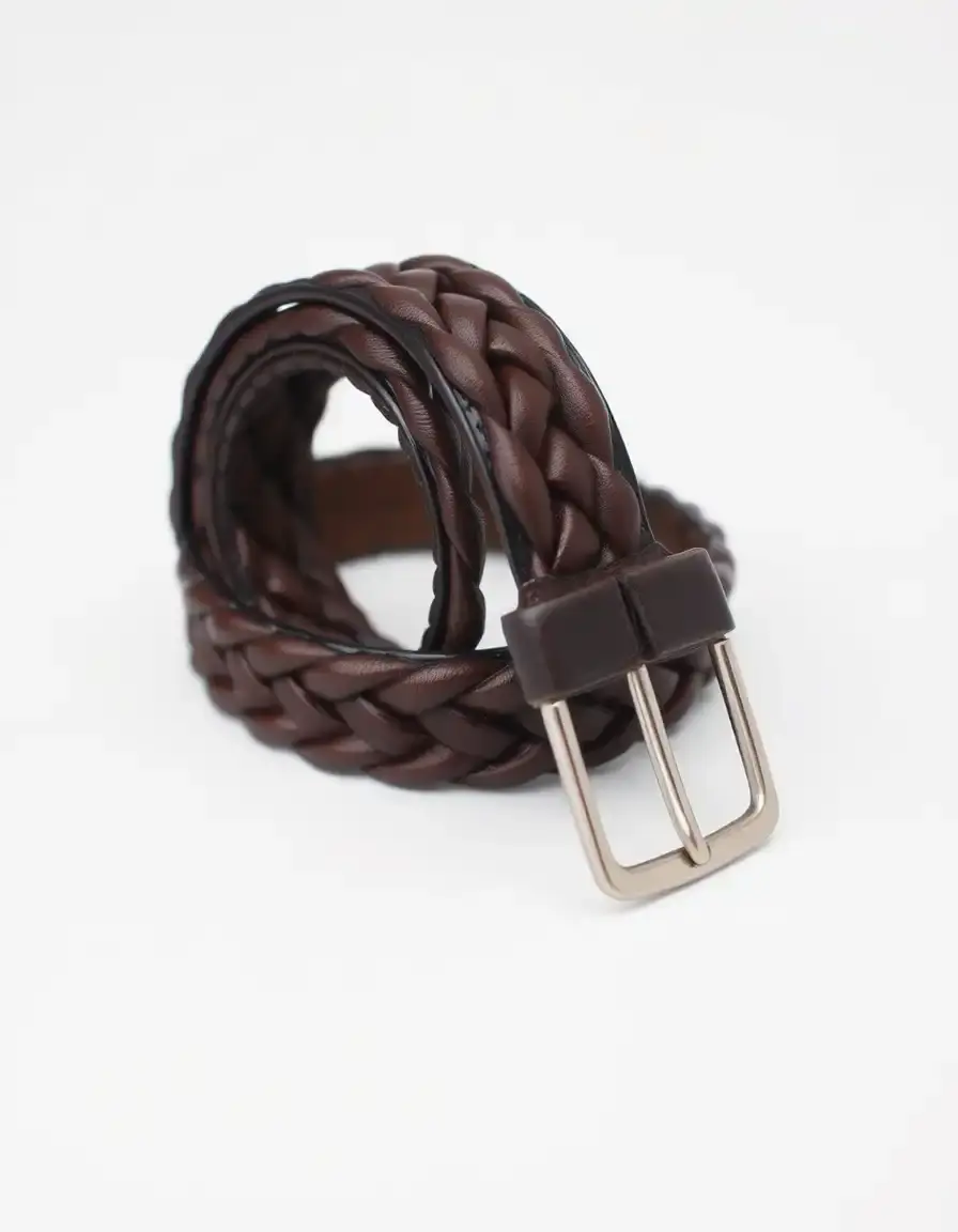 Intricately braided brown leather belt showing rich texture
