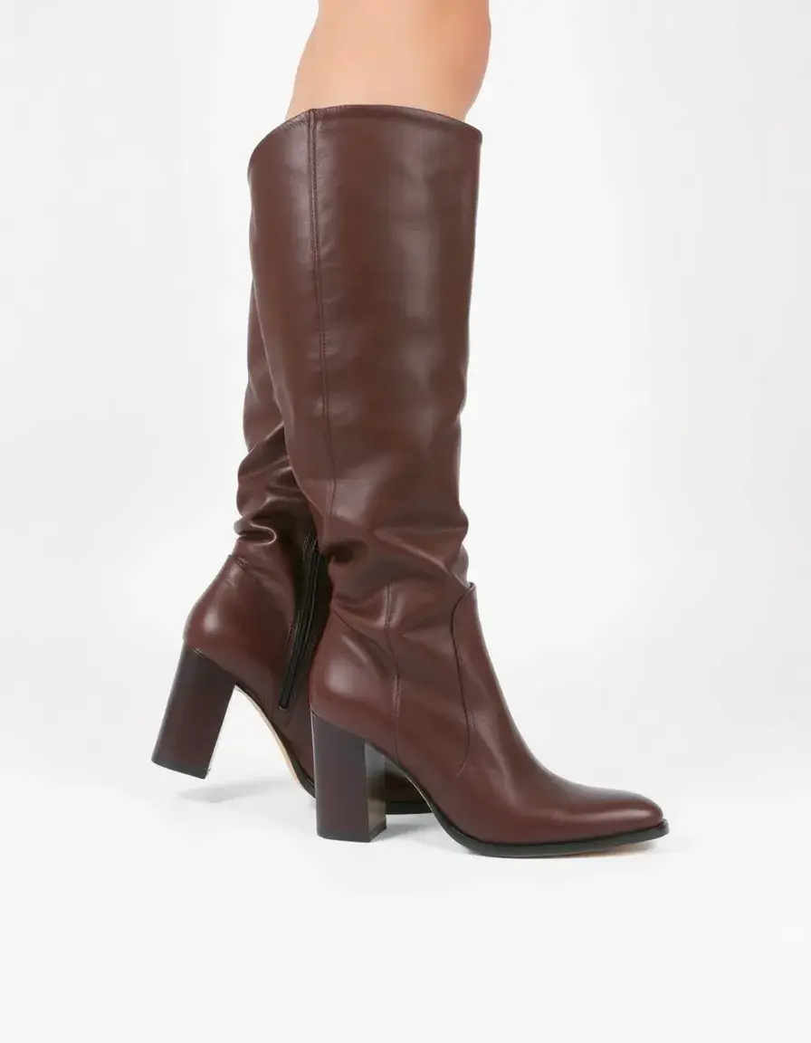 Brown heeled knee high leather boots with stacked heel