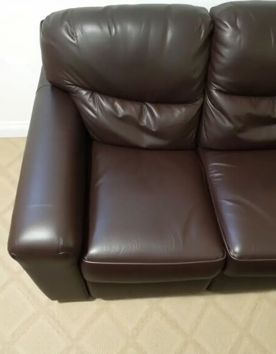 Close-up of a high-quality three-seater leather sofa showing grain texture