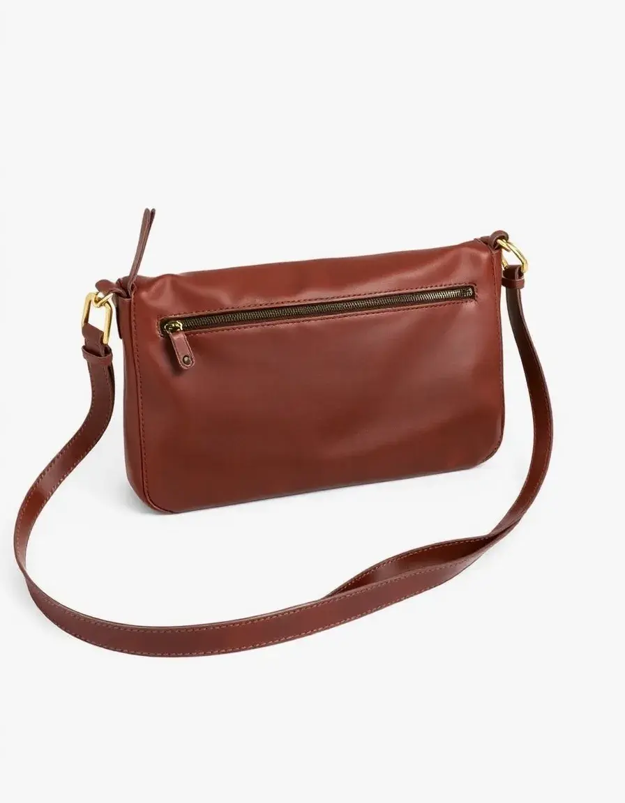 Adjustable strap leather crossbody bag in a lifestyle setting