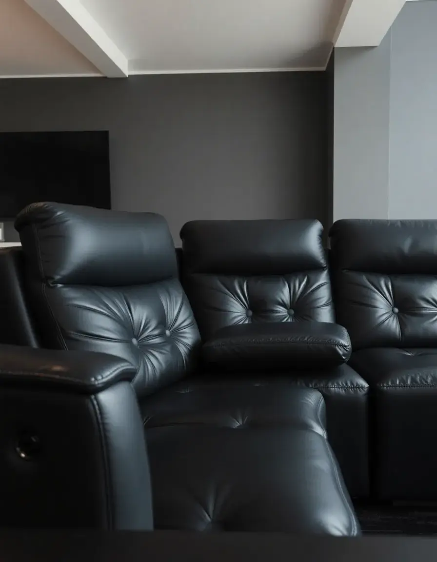 A black leather sectional with recliner seats